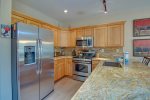 Remodeled kitchen with granite countertops and stainless steel appliances